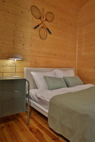 a bedroom with a bed and a ceiling fan at SikorQa Domek nad jeziorem in Skrzeszew