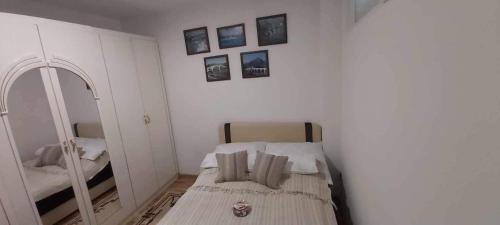 a small room with a bed and a mirror at Mima in Sarajevo