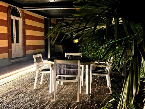 a table and chairs on the porch of a house at Villa Marchesa in Arona