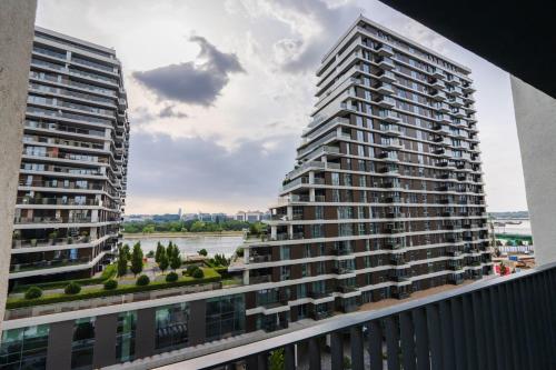 two tall buildings are seen from a balcony at Terra river view in Sajmište