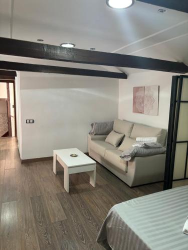 a living room with a couch and a table at Apartamentos Mayte in Toledo