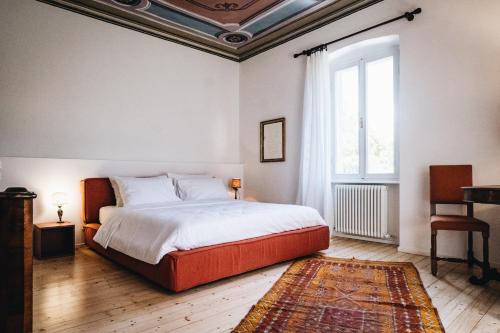 a bedroom with a large bed and a window at La Corte di San Rocco in Trento