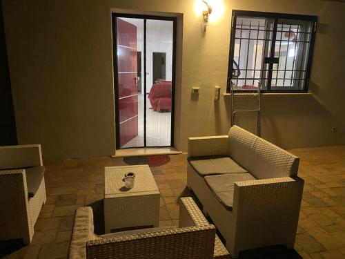 a living room with chairs and a couch and a table at Alloggio turistico Villa Camelia Lavinio in Anzio