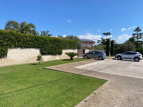 two cars are parked in a parking lot at Alloggio turistico Villa Camelia Lavinio in Anzio