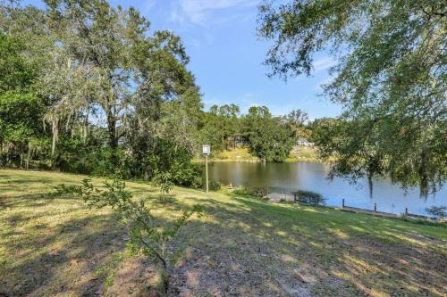 a view of a lake with trees and a park at Stunning Lake House with Heated Pool & Ping Pong! in Lutz