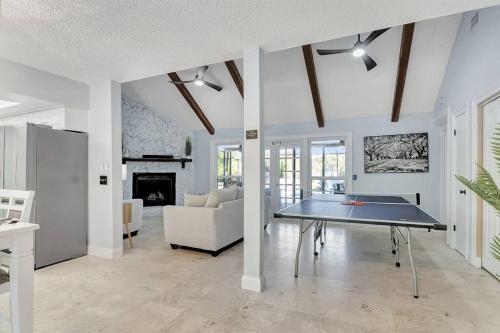 a living room with a ping pong table in it at Stunning Lake House with Heated Pool & Ping Pong! in Lutz