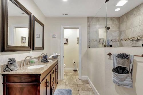 a bathroom with a sink and a shower at Stunning Lake House with Heated Pool & Ping Pong! in Lutz