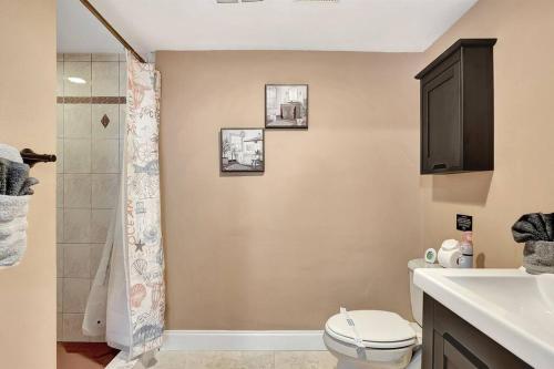 a bathroom with a toilet and a sink and a shower at Stunning Lake House with Heated Pool & Ping Pong! in Lutz