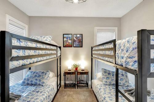 a room with two bunk beds and a table at Stunning Lake House with Heated Pool & Ping Pong! in Lutz
