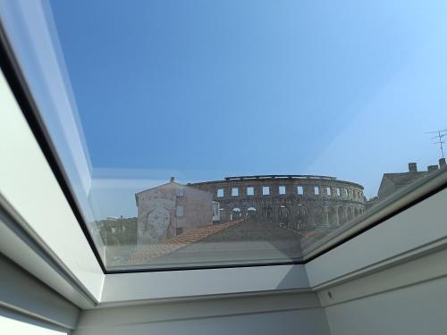 a view of the colosseum from the roof of a building at D&A Amphitheatre Premium Apartments with FREE Parking in Pula