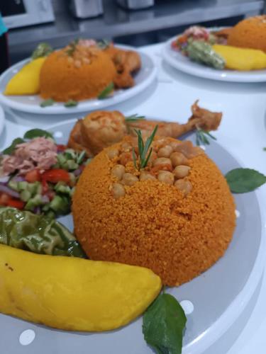 a plate of food with nuts and vegetables on a table at Maison des Oliviers, Yasmine Hammamet, Bouficha in Hammamet Sud