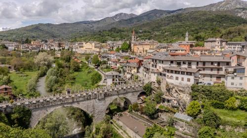 an old bridge over a river in a town at Ca'Maira Dronero in Dronero