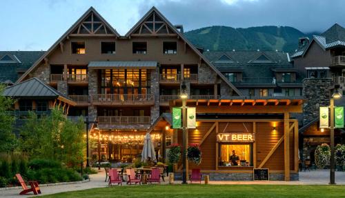 a hotel with a restaurant in front of a building at 374 Lodge At Spruce Peak Ski In Ski In Ski Out King Studio By Stowe Mountain Rentals in Stowe