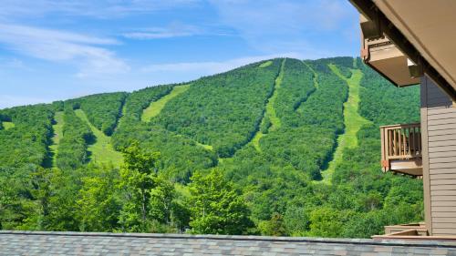 a view of the mountains from a building at 378 Lodge At Spruce Peak Ski In Ski In Ski Out King Studio By Stowe Mountain Rentals in Stowe