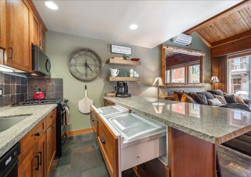 a kitchen with a large clock on the wall at Cozy Northstar Village Condo Walk to Lifts 2 Full BA Excellent Location in Truckee
