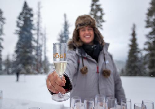 a woman is holding a glass of wine at Cozy Northstar Village Condo Walk to Lifts 2 Full BA Excellent Location in Truckee