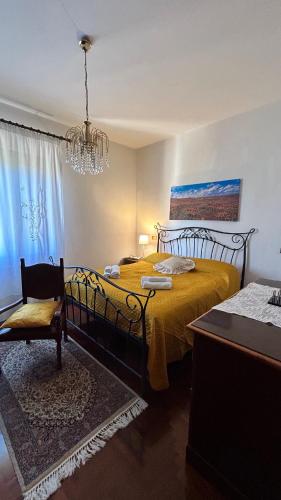 a bedroom with two beds and a chandelier at I Tigli in Sellano