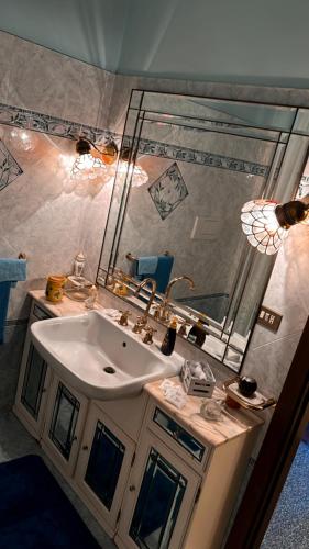 a bathroom with a sink and a mirror at I Tigli in Sellano