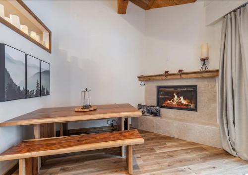 a living room with a fireplace and a wooden table at Northstar Village Condo Walk to Lifts 2 Full BA Excellent Location Hot-Tubs in Truckee