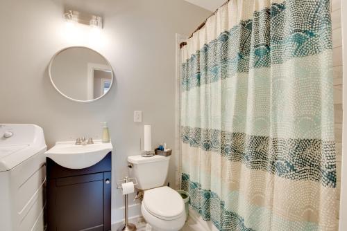 a bathroom with a toilet and a sink and a mirror at 6 Mi to World Cup! Pet-Friendly ATL Home with Yard in Atlanta