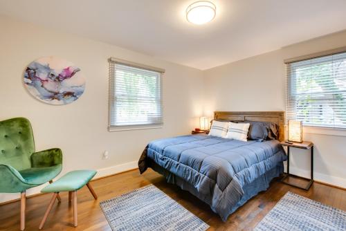 a bedroom with a bed and a chair and two windows at 6 Mi to World Cup! Pet-Friendly ATL Home with Yard in Atlanta