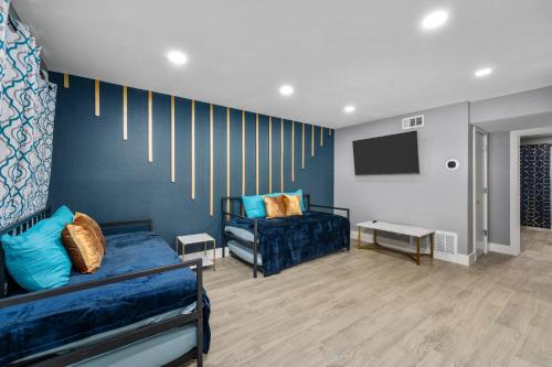 a living room with a bed and a tv at Heights 1BR Chic Apt with King Bed & Pool in Houston