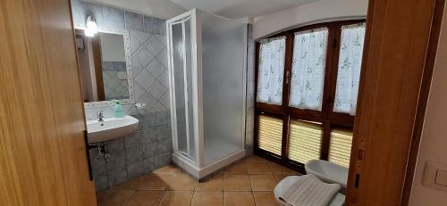 a bathroom with a sink and a toilet and a mirror at Nurache in Orosei