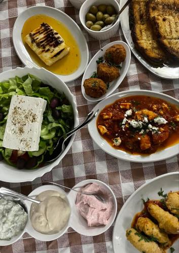 a table with plates of food on a table at Eliofos Elegant Maisonettes in Polis Chrysochous