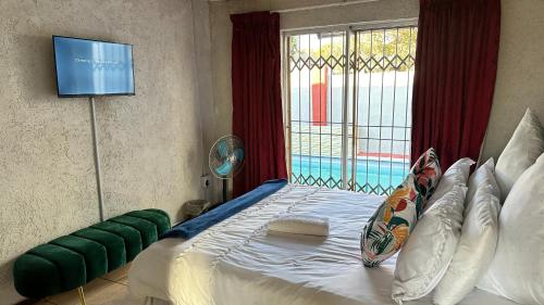 Ένα ή περισσότερα κρεβάτια σε δωμάτιο στο Nyasa Guest House in Johannesburg