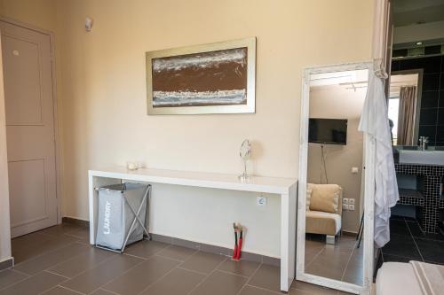a bathroom with a white counter and a mirror at Villa Sorina Kefalonia in Svoronata