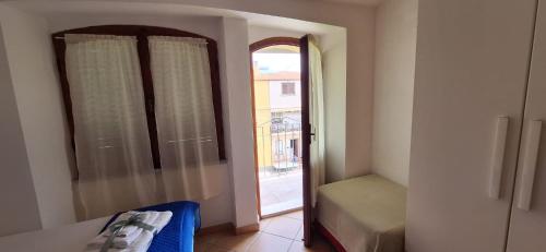 a room with a door to a window with a view at Nurache in Orosei