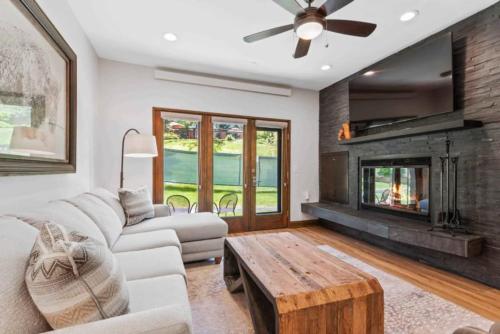 a living room with a couch and a fireplace at The Charter at Beaver Creek E030 in Beaver Creek