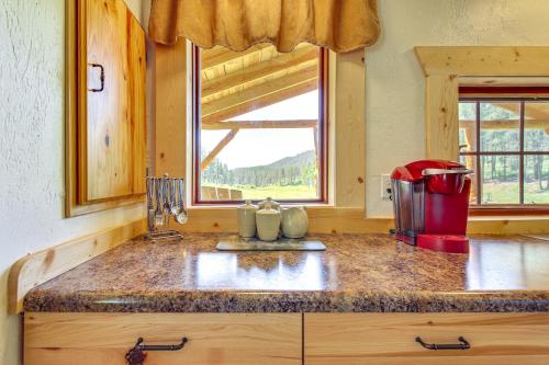 a kitchen with a counter top and a window at Remote Custer Cabin with Fire Pit and Near State Park! in Custer