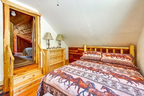 a bedroom with a bed and a mirror at Remote Custer Cabin with Fire Pit and Near State Park! in Custer