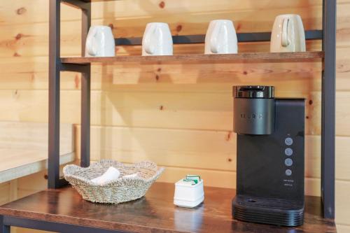 a coffee maker on a table in a room at Dog-Friendly A-Frame with Firepit and Fall Foliage in Hedgesville