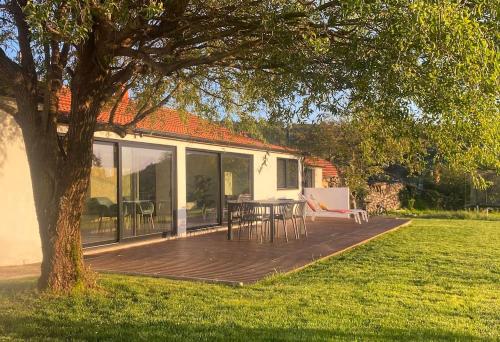 a house with a deck with a table and chairs at Casa do Sol - Natureza & Lazer - Serra da Freita in Arouca