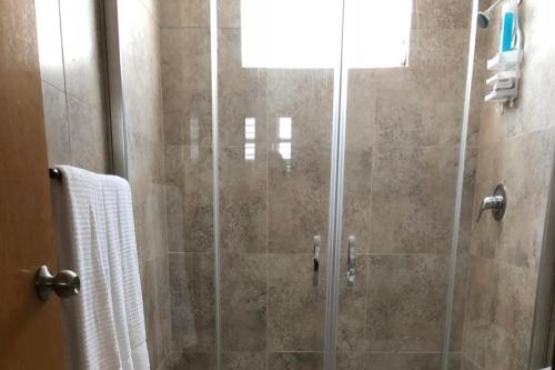 a bathroom with a shower with a glass door at Villas frente al mar Ponce Puerto Rico in Tallaboa