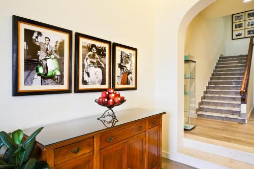 a room with four pictures on the wall and a staircase at Hotel Italia in Siena