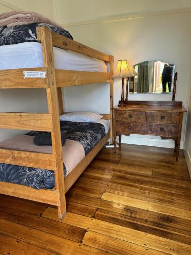 a bedroom with two bunk beds and a mirror at Seacroft Estate in Apollo Bay