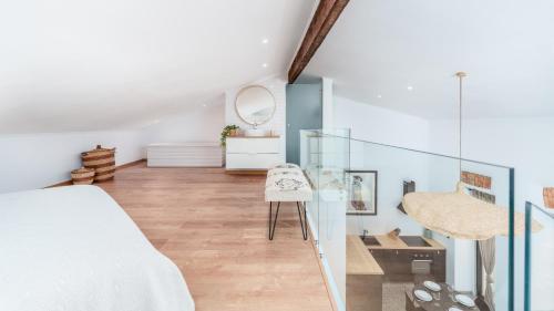 a bedroom with a bed and a mirror and a chair at Unique Beautifully Restored Town House in Loulé