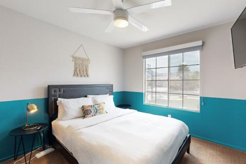 a bedroom with a large bed and a window at Deerbrook Manor Permit# 67085 in La Quinta