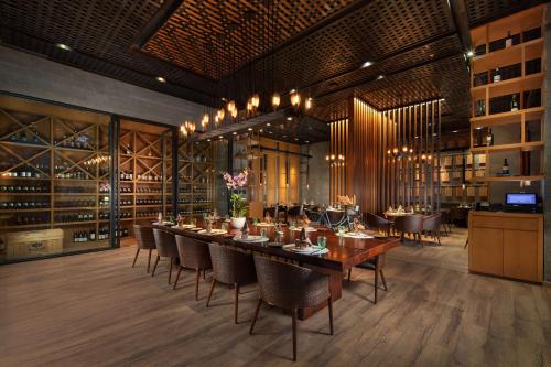a dining room with a long table and chairs at Radisson Blu Bali Uluwatu in Uluwatu
