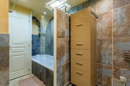 a bathroom with a shower and a sink and a tub at le loft du vieux lyon in Lyon