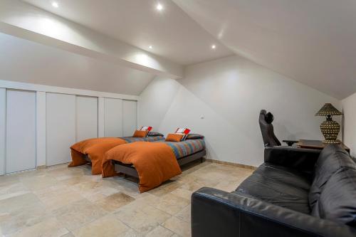 a bedroom with a bed and a couch at le loft du vieux lyon in Lyon