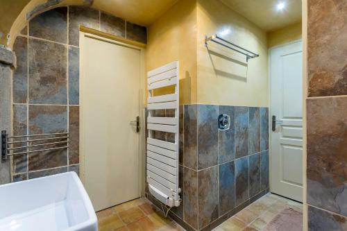 a bathroom with a shower and a tub and a sink at le loft du vieux lyon in Lyon