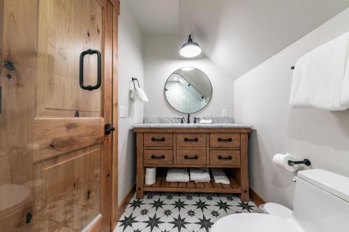 a bathroom with a sink and a mirror at Eclipse Retreat at Tahoe Park - Hot Tub - Fenced Yard & steps to HOA Access in Tahoe City