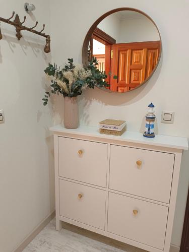 a dresser with a mirror on top of it at Preto do Mar in Corcubión