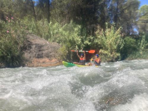 two people in a kayak on a river at Aer Rural Apartment - Casillas Valle de Ayora in Jalance