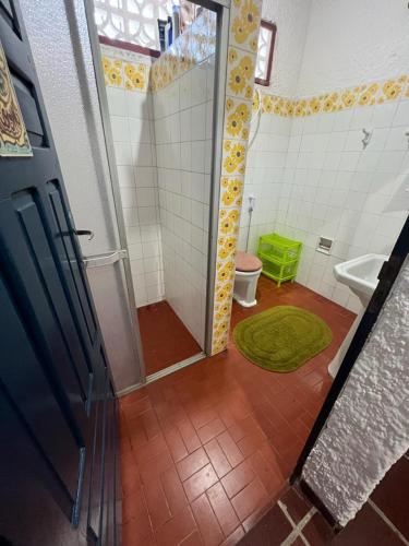 a bathroom with a shower with a toilet and a sink at Recanto do Sal, casa completa com SKY e WI-FI in Salinópolis