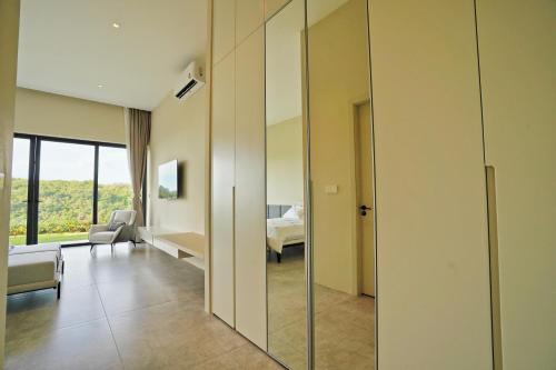 a living room with a glass partition with a bedroom at Green Lotus Samui in Ban Bang Po